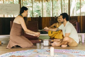 Shipibo healer singing icaros by candlelight during a traditional ayahuasca ceremony